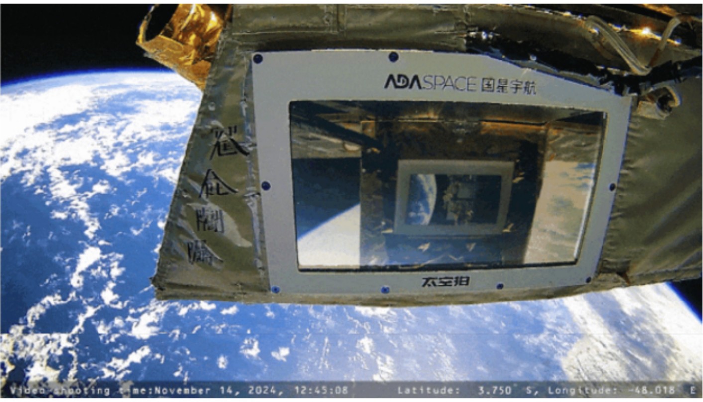 Gold-foiled satellite panel with a screen facing the Earth below, from footage returned by SCA-2.